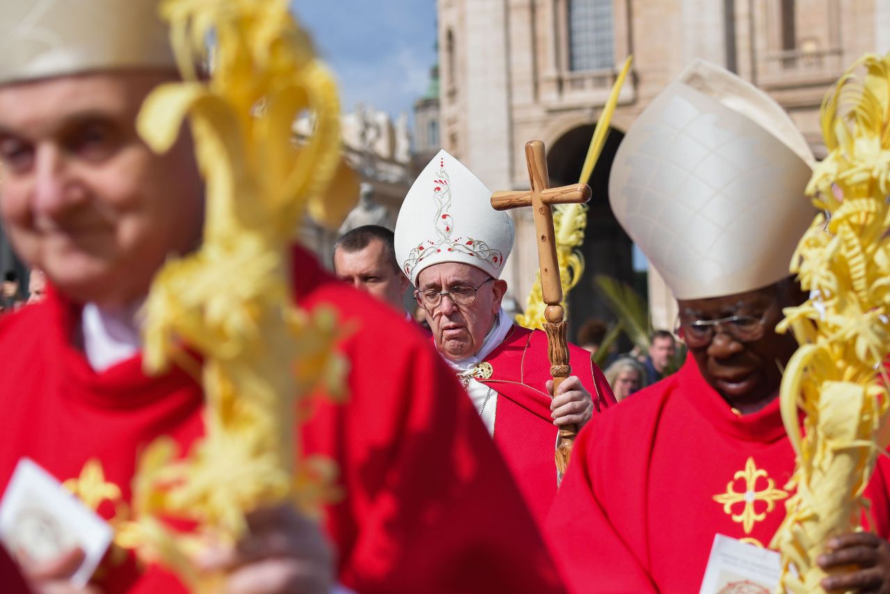 The Pope walks with cardinals during a Palm Sunday Mass in April 2019.
