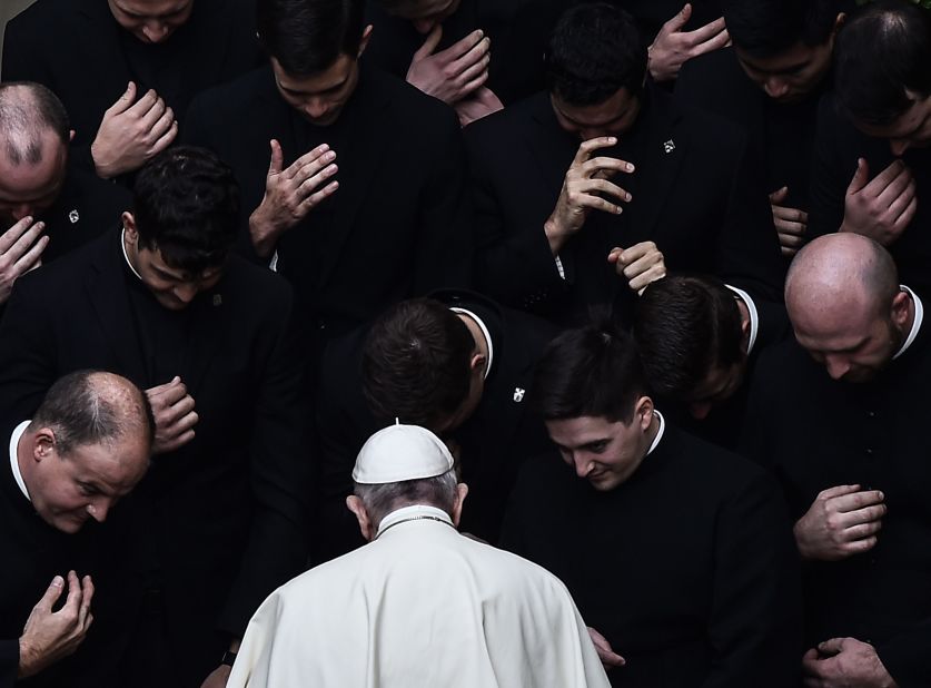 The Pope prays with priests in a Vatican courtyard in September 2020.