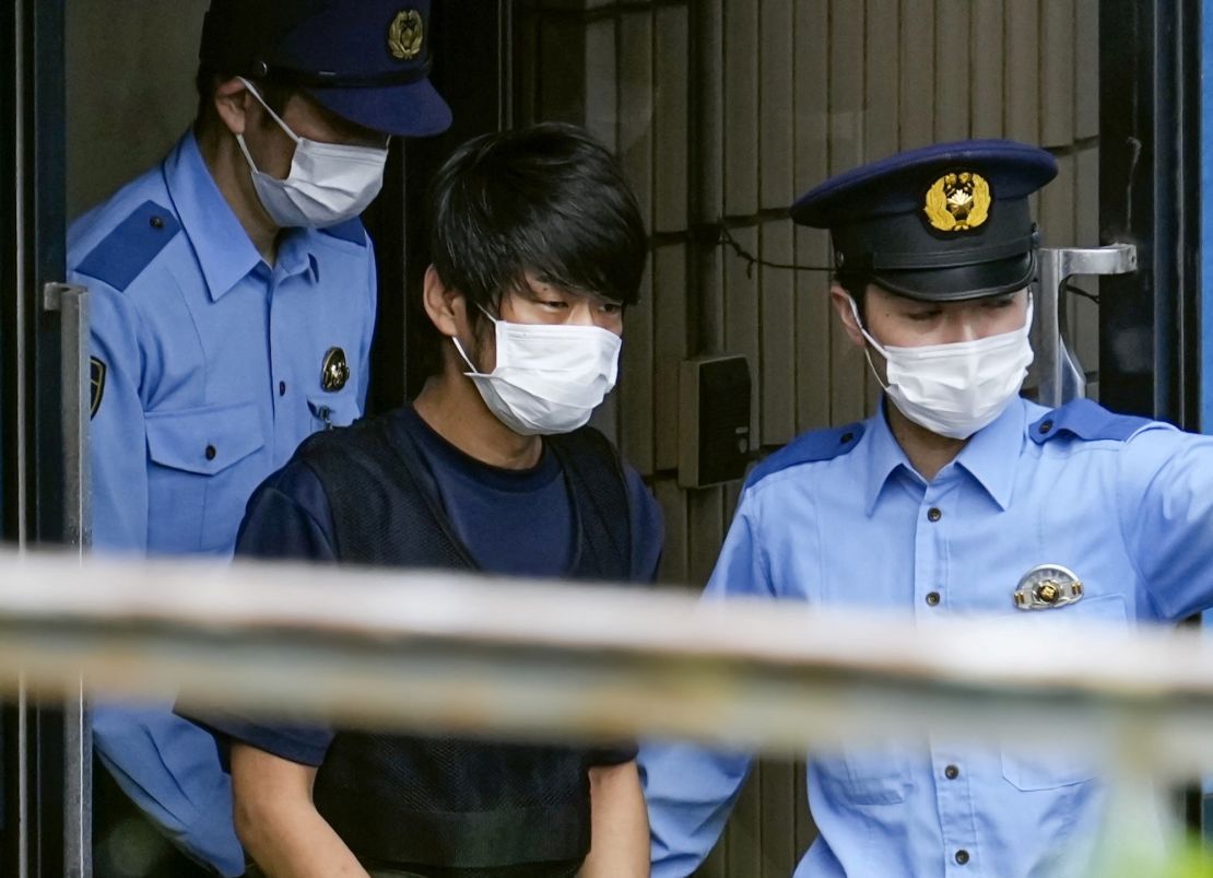 Tetsuya Yamagami, suspected of killing former Japanese Prime Minister Shinzo Abe, is escorted by police officers in Nara, Japan, on July 10, 2022.