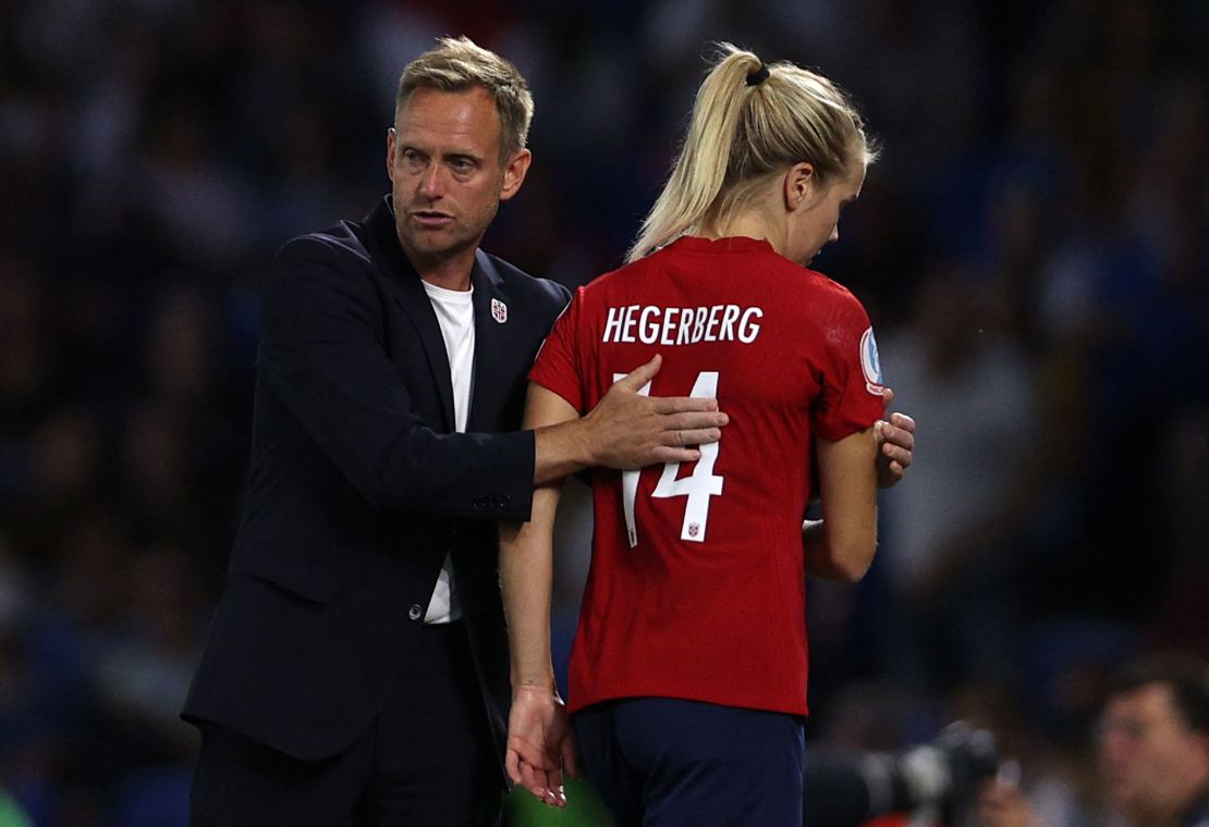 Norway's head coach Martin Sjögren consoles Ada Hegerberg as she leaves the pitch.