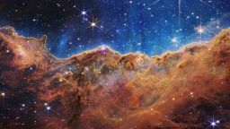 This landscape of "mountains" and "valleys" speckled with glittering stars is actually the edge of a nearby, young, star-forming region called NGC 3324 in the Carina Nebula. Captured in infrared light by NASA's new James Webb Space Telescope, this image reveals for the first time previously invisible areas of star birth. 