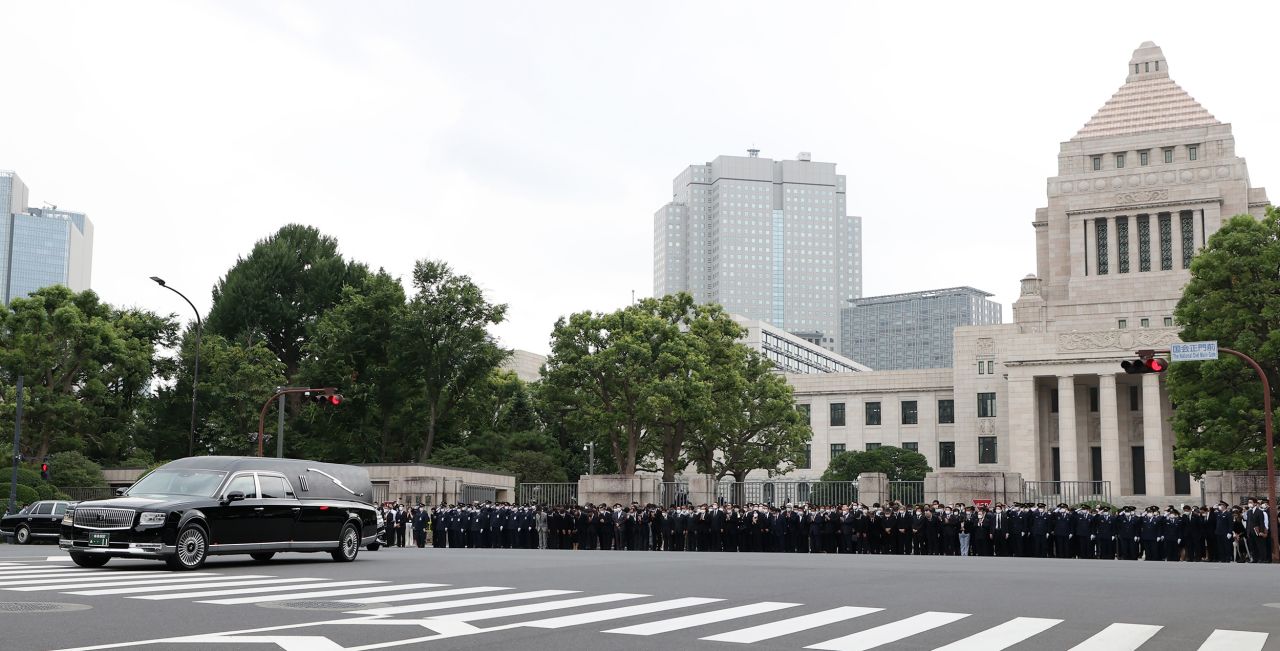 A hearse carrying the body of former Japanese Prime Minister Shinzo Abe passes in front of the Diet Building after his funeral in Tokyo on July 12.