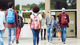 Students walk at school - stock photo