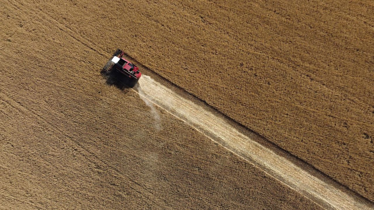 This aerial picture taken on July 7, 2022 shows a farmer harvesting wheat near Kramatosk in the Donetsk Oblast, Ukraine.