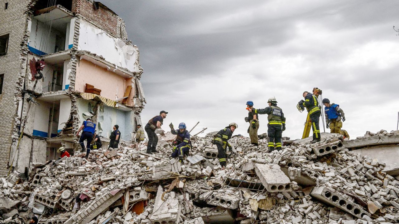 Firefighters and members of a rescue team clear the scene after a building was shelled in Chasiv Yar, eastern Ukraine, on July 10. <a target=