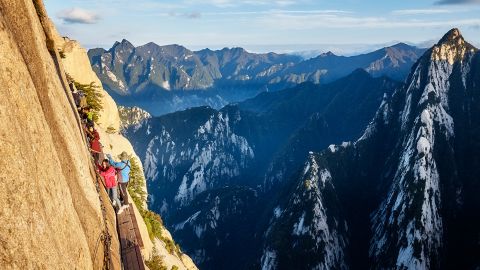 Mount Hua, Shaanxi Province, China - October 6, 2017: Tourists on the Plank Walk in the Sky, worlds most dangerous trail.