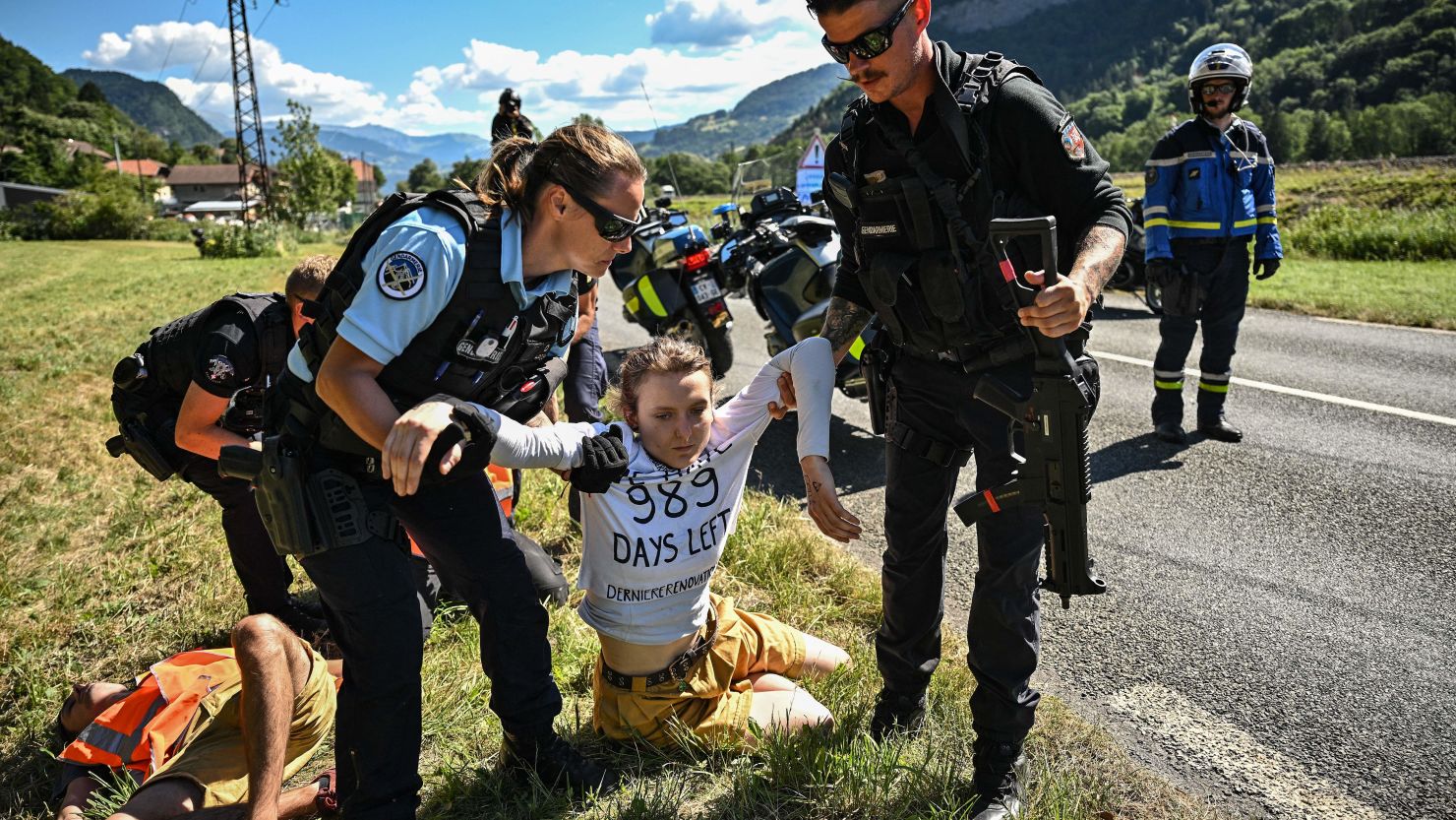 French gendarmes removed environmental protestors from the race route.