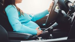 Independant pregnant woman driving a car. Woman dring a car during her pregnancy.