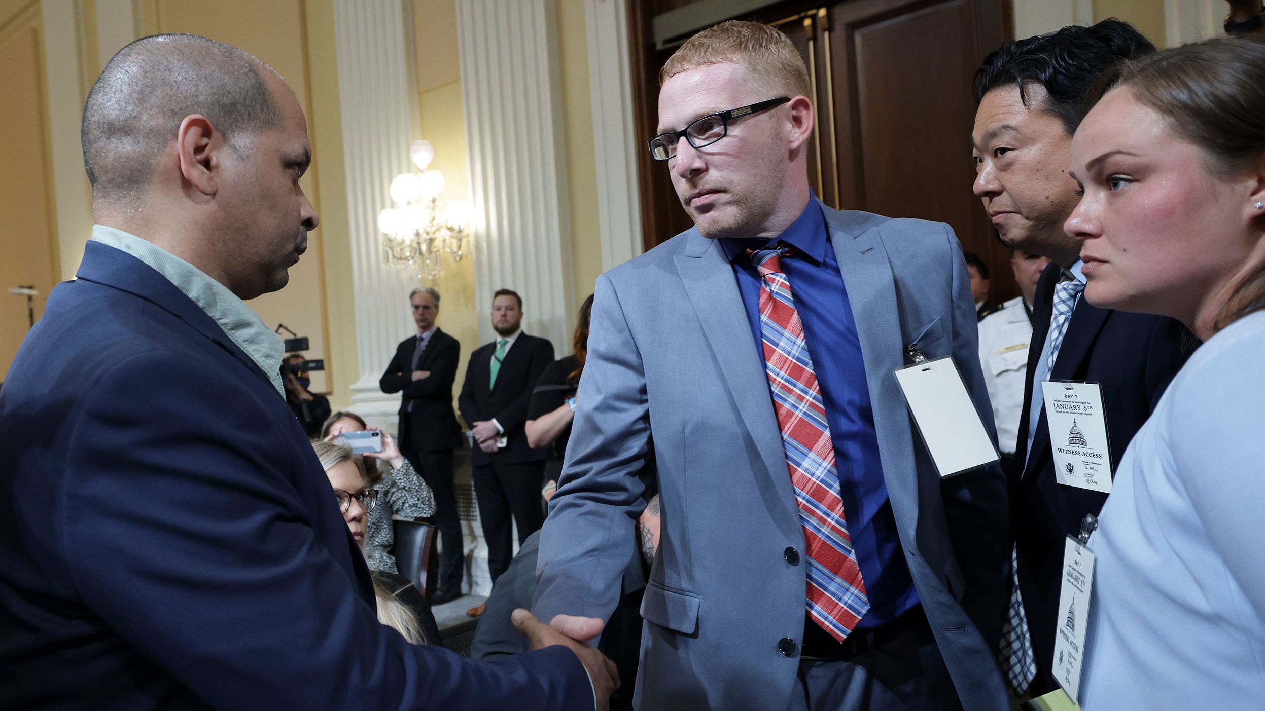 Stephen Ayres, second from left, shakes hands with Gonell after giving testimony to the committee. Ayres was one of the Capitol rioters on January 6. Gonell was one of the officers who defended the Capitol that day, and we learned that the injuries he suffered in the attack <a href="index.php?page=&url=https%3A%2F%2Fwww.cnn.com%2Fpolitics%2Flive-news%2Fjanuary-6-hearings-july-12%2Fh_041b239e77bddbc2c84274b0ca1adbdf" target="_blank">are forcing him to quit policing.</a>