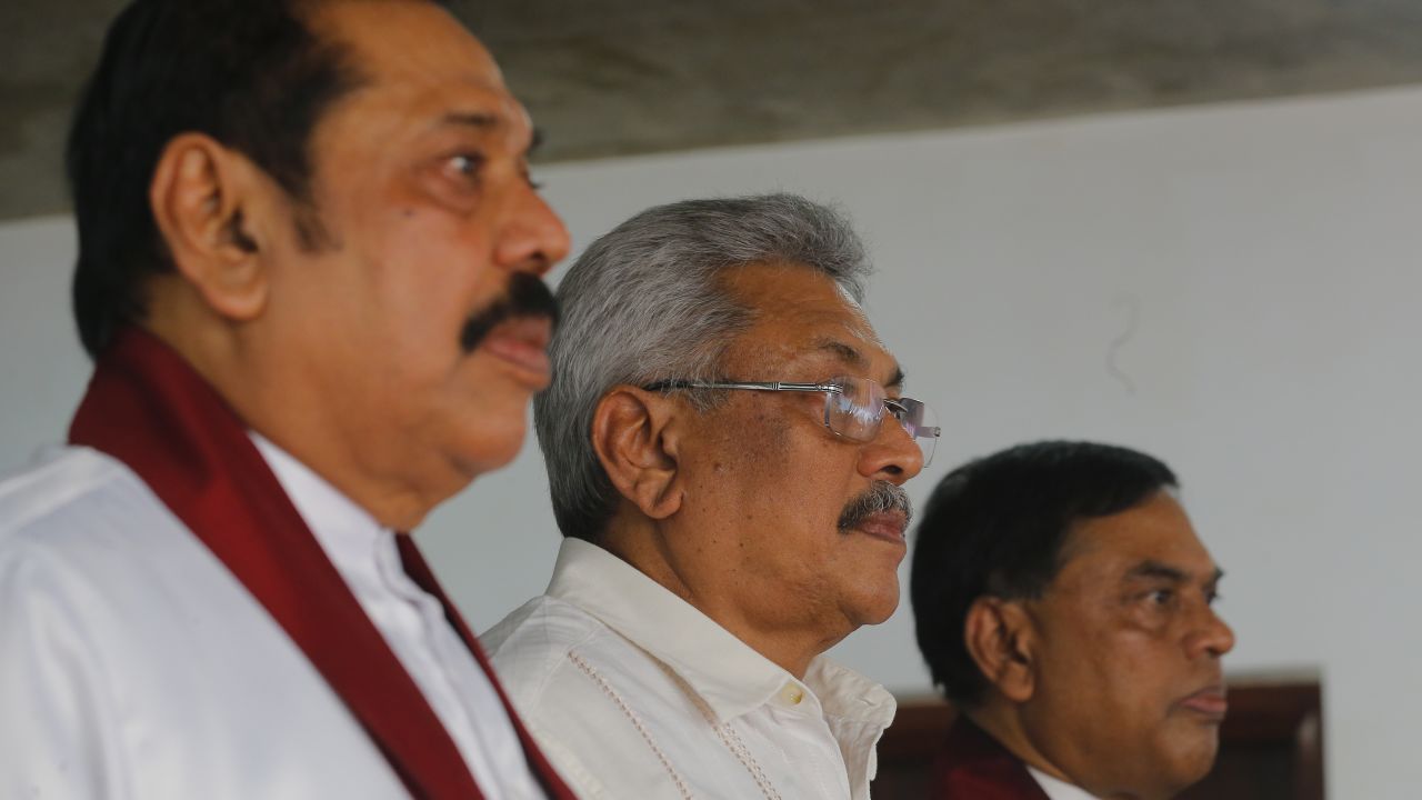 Sri Lanka's former president Mahinda Rajapaksa, left, along with his brothers former defense secretary Gotabhaya Rajapaksa, center, and former economics development minister Basil Rajapaksa, attend a meeting at their party office with local politicians in Colombo, Sri Lanka, Wednesday, July 4, 2018. (AP Photo/Eranga Jayawardena)