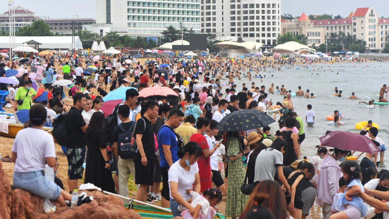 People swarm to the beach in the summer heat in Qingdao, China, on July 10.
