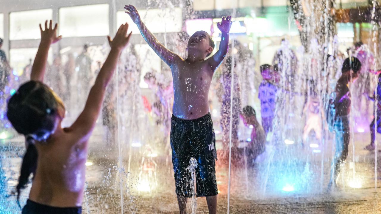 Children cool off at a fountain during a hot day on July 12 in Nanning, China.