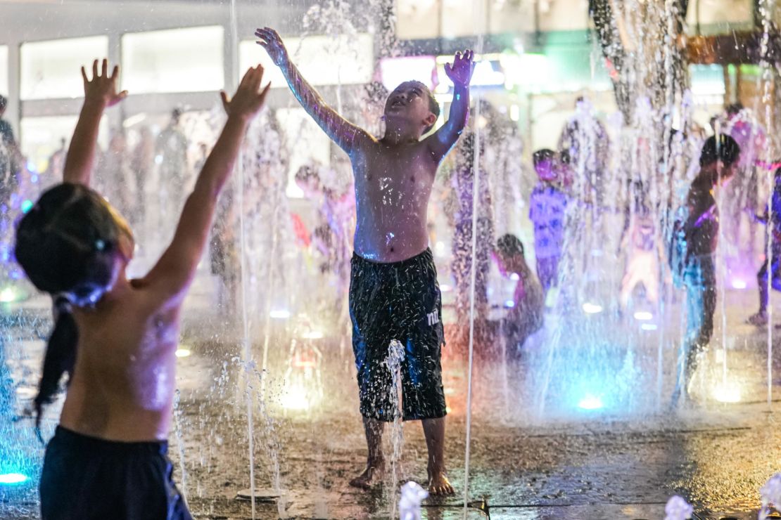 Children cool off at a fountain during a hot day on July 12 in Nanning, China.