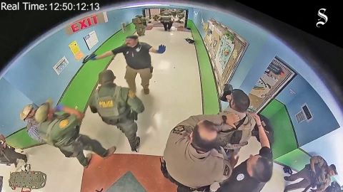 School surveillance video obtained by the Austin American-Statesman shows officers in the hallway of Robb Elementary during the shooting. 
