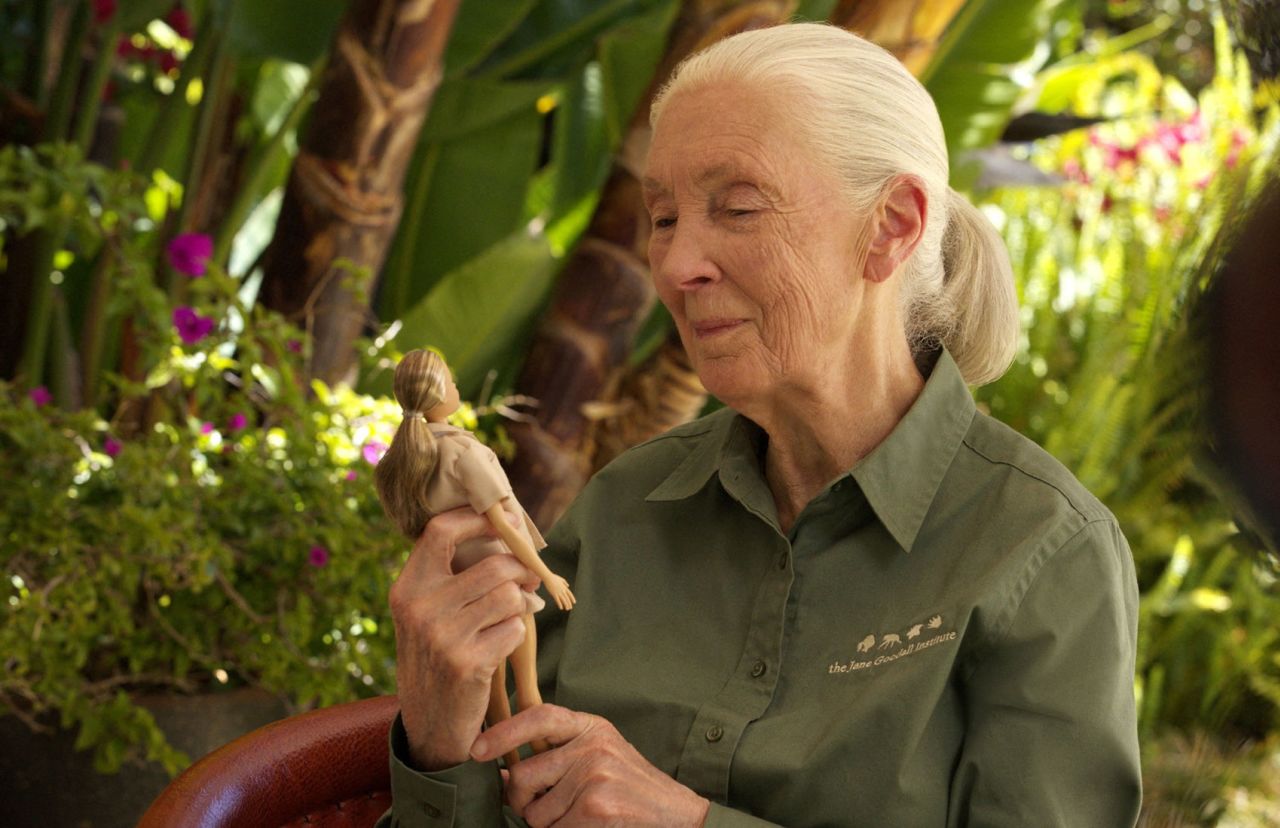 Jane Goodall holds the new Barbie doll. 