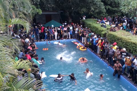 Protesters swim in a pool after breaching the presidential compound in Colombo, Sri Lanka, on Saturday, July 9. Protesters also broke into the Sri Lankan prime minister's office this week <a href="http://www.cnn.com/2022/07/09/asia/gallery/sri-lanka-crisis-protests/index.html" target="_blank">as they demanded the resignation of the country's leaders.</a> Sri Lanka is suffering its worst financial crisis in recent history, leaving millions struggling to buy food, medicine and fuel.
