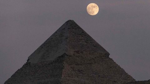 The moon moon rises over the Pyramid of Khafre (Chephren) at the Giza Pyramids necropolis on the southwestern outskirts of the Egyptian capital on July 12, 2022.