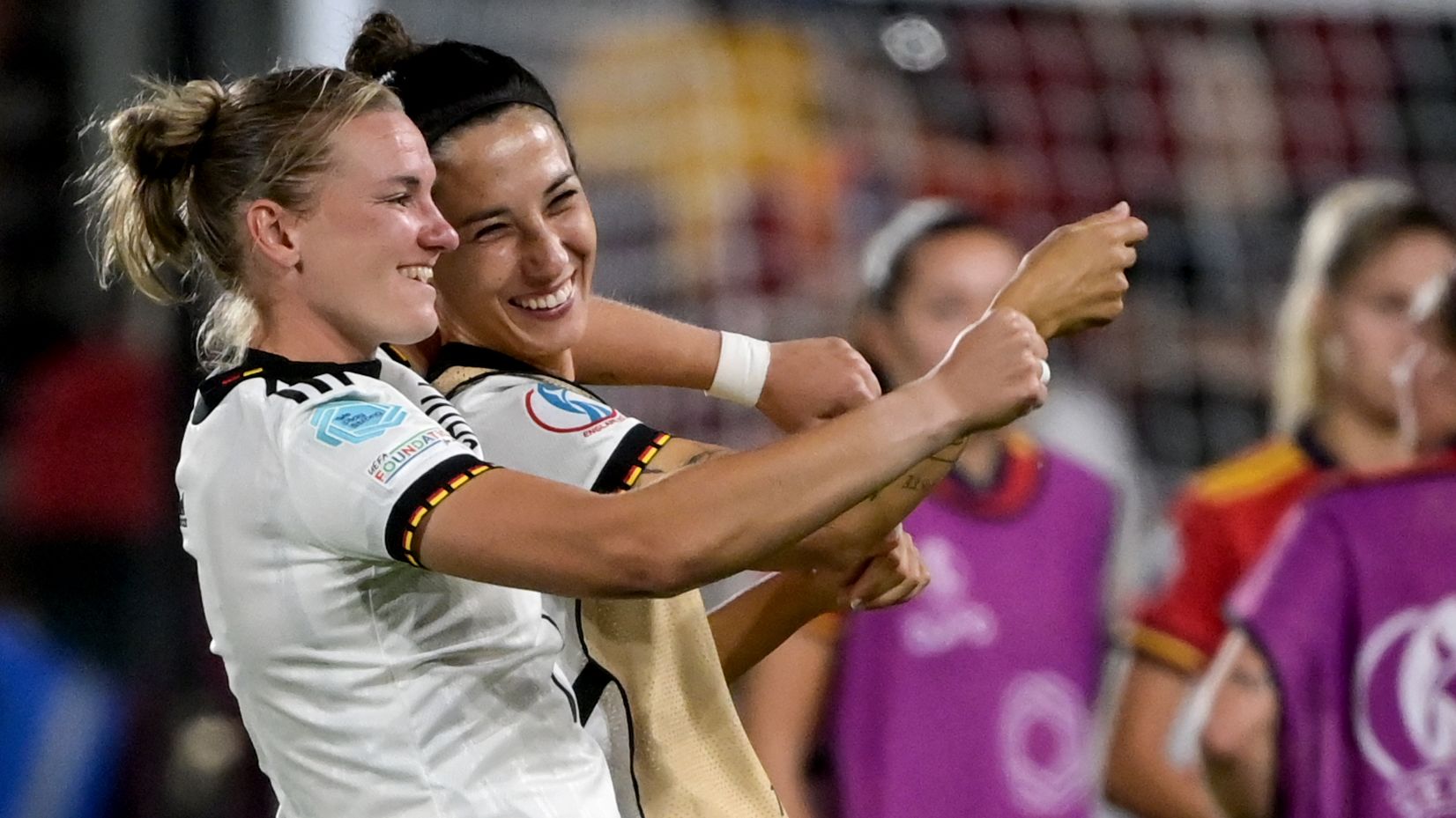 Germany's Alexandra Popp and Sara Doorsoun celebrate after beating Spain.