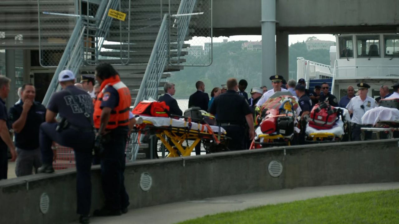 Emergency personnel gather after two people died Tuesday when a boat capsized in the Hudson River off Manhattan.