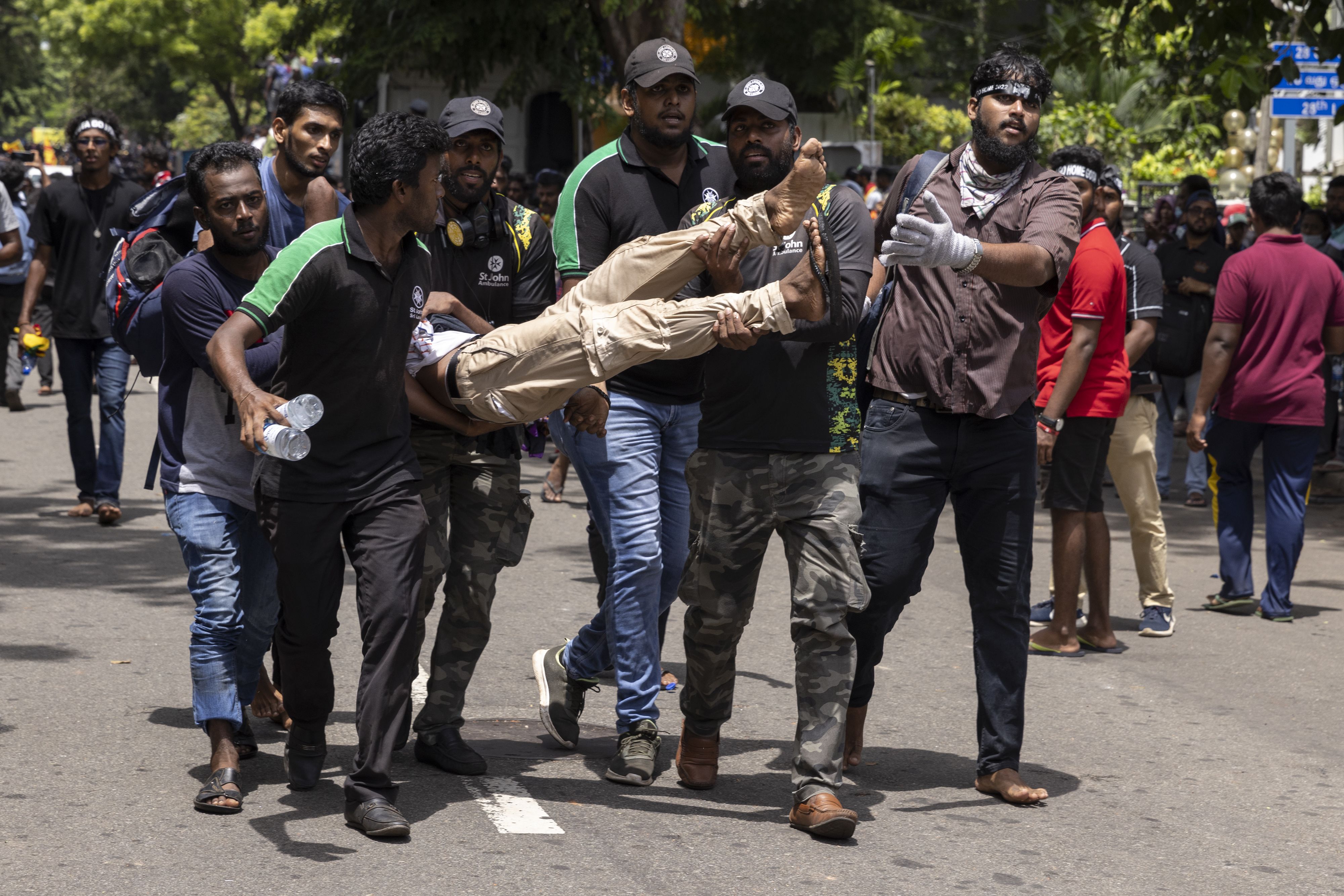 People help an injured protester in Colombo on Wednesday.