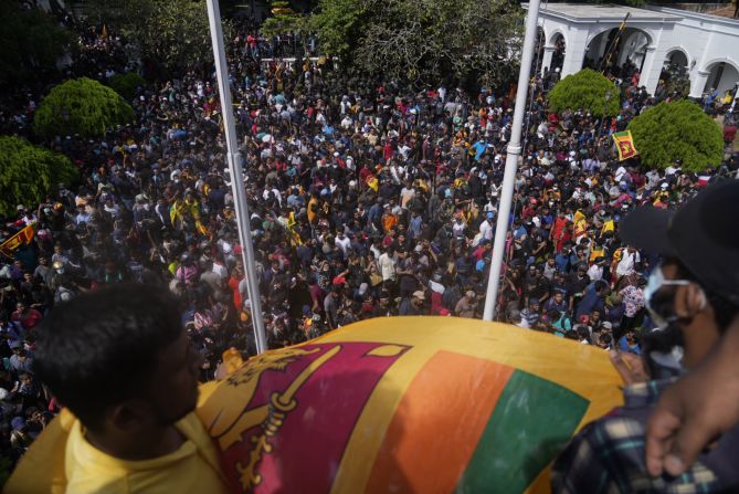 Protesters wave the national flag after entering the prime minister's office.