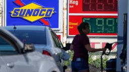 A woman pumps gas at a Sunoco mini-mart in Independence, Ohio, on Tuesday, July 12, 2022.