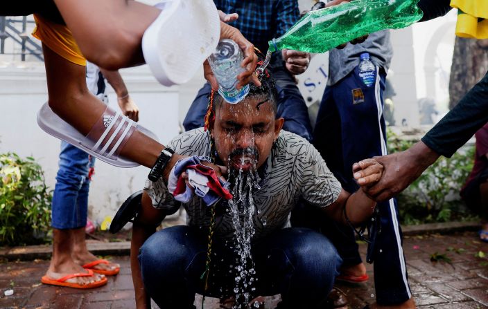 People help a protester who was affected by tear gas on Wednesday.