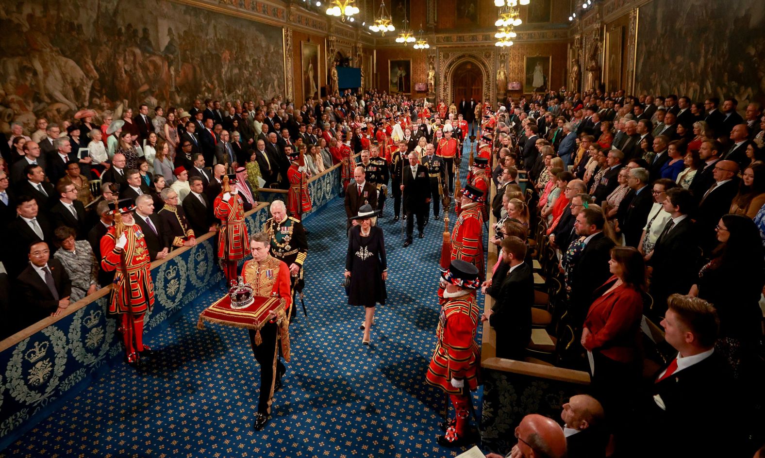 Charles and Camilla walk behind the Imperial State Crown during the state opening of Parliament in May 2022.