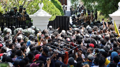 Demonstrators carry the gate of the prime minister's office during a protest in Colombo on July 13. 