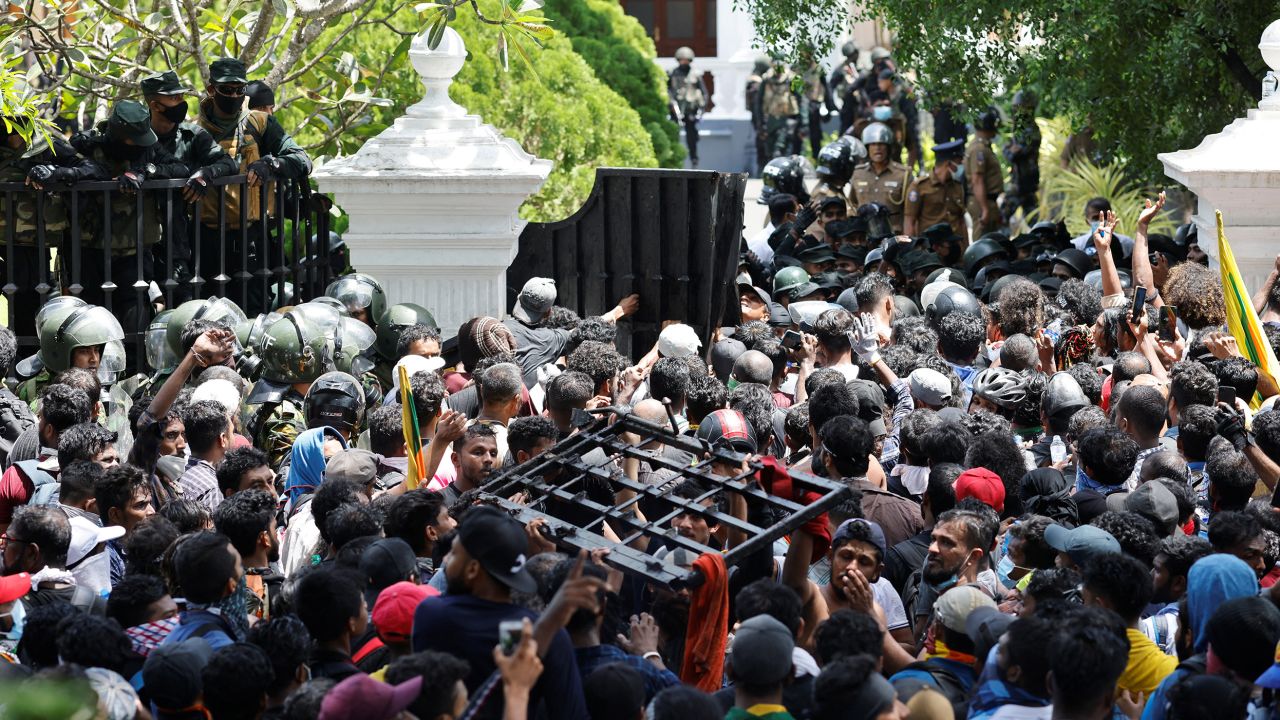Demonstrators carry the gate of the prime minister's office during a protest in Colombo on July 13. 