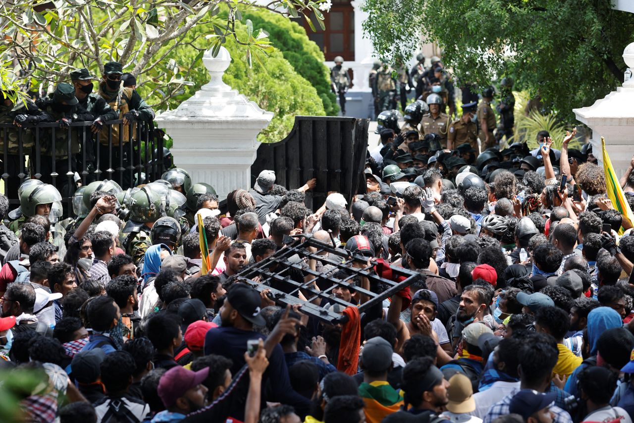 Protesters break down the gate to the prime minister's office on Wednesday.