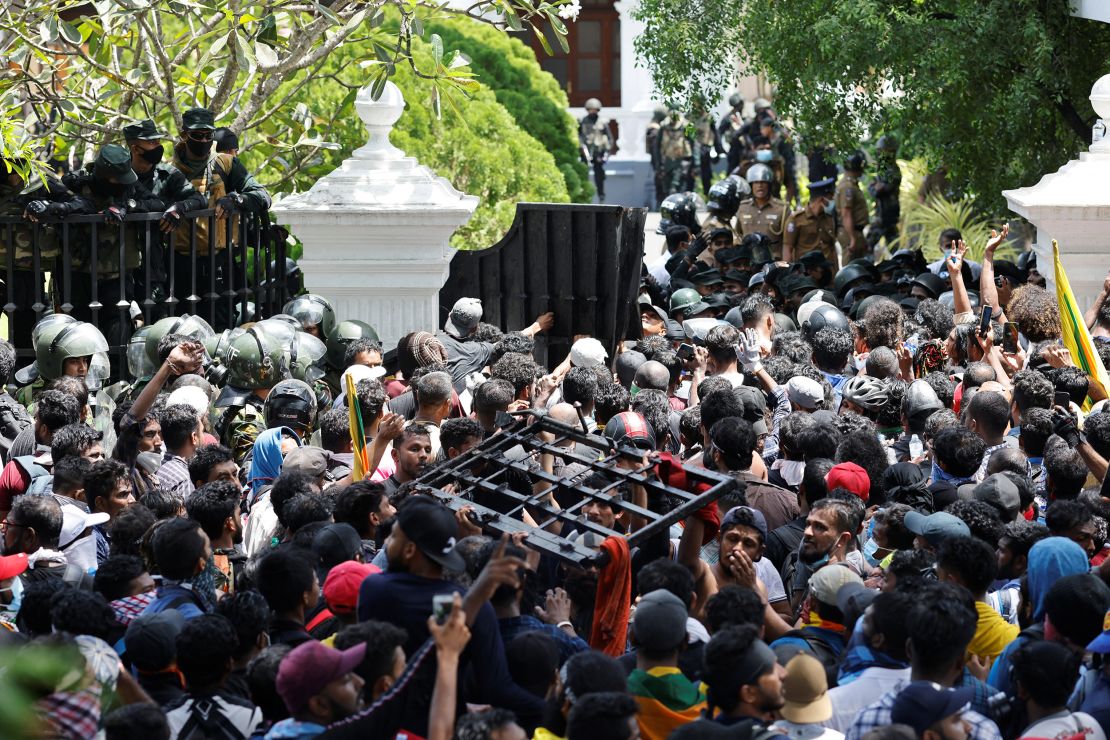 Demonstrators carry the gate to Sri Lanka's Prime Minister Ranil Wickremesinghe's office premises, during protests in Colombo on Wednesday.