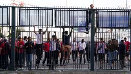 People try to climb gates outside the ground as the kick off is delayed during the UEFA Champions League Final at the Stade de France, Paris. Picture date: Saturday May 28, 2022. 