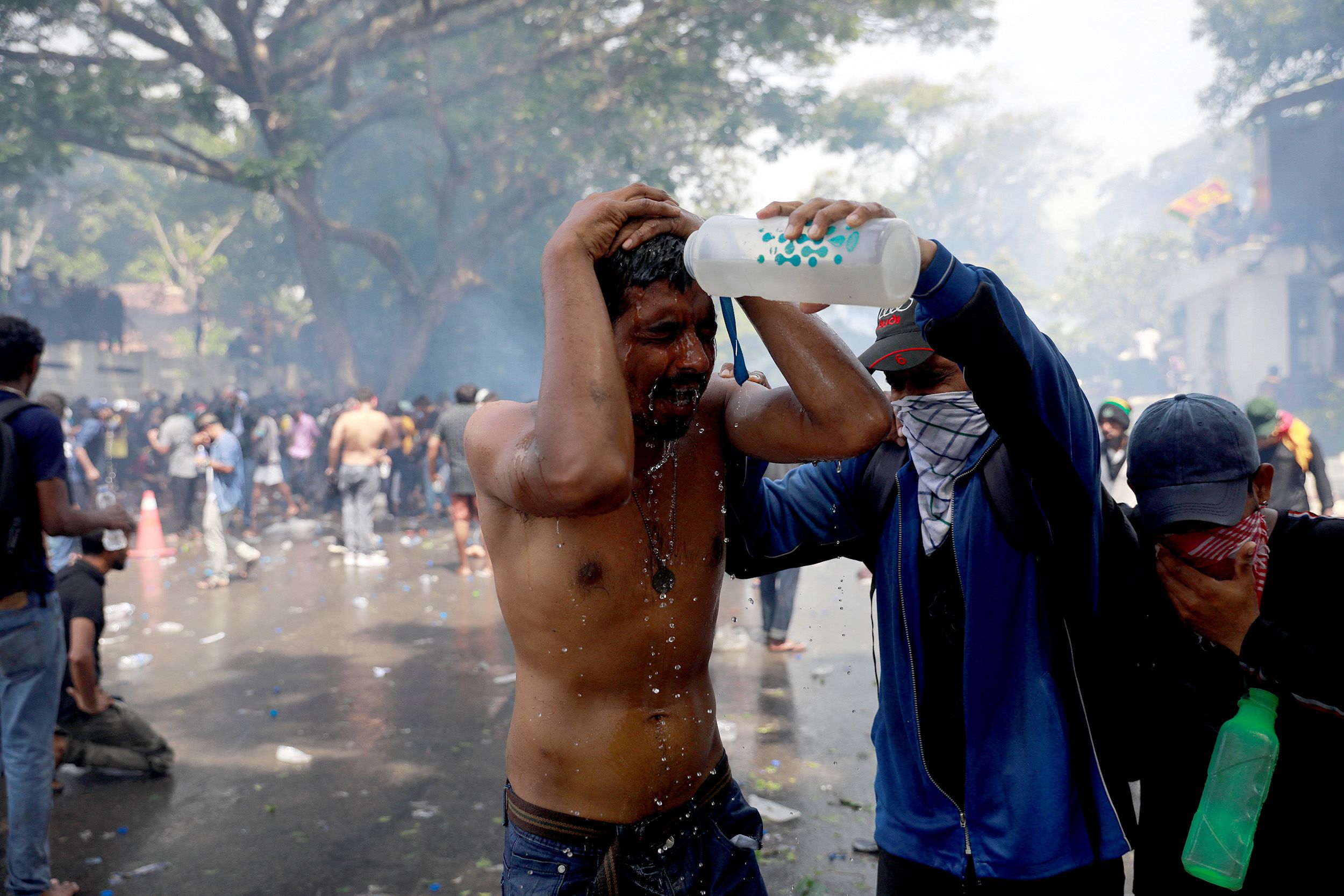 A protester pours water on a man outside the prime minister's office.