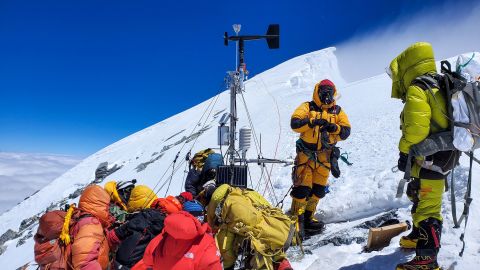 The expedition team constructs the weather station at Bishop Rock, the highest weather station in the world.