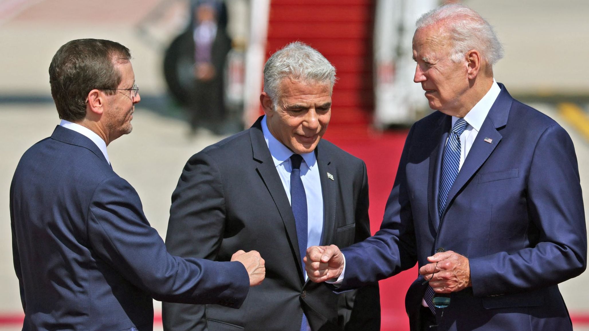 After Air Force One arrived in Israel, Biden was greeted by Lapid and Herzog. The White House said the fist bumps are <a href="https://www.cnn.com/2022/07/13/politics/handshakes-joe-biden-israel/index.html" target="_blank">part of an effort to reduce physical contact</a> amid the rapid spread of a new coronavirus variant. But Biden was later seen shaking hands as well.
