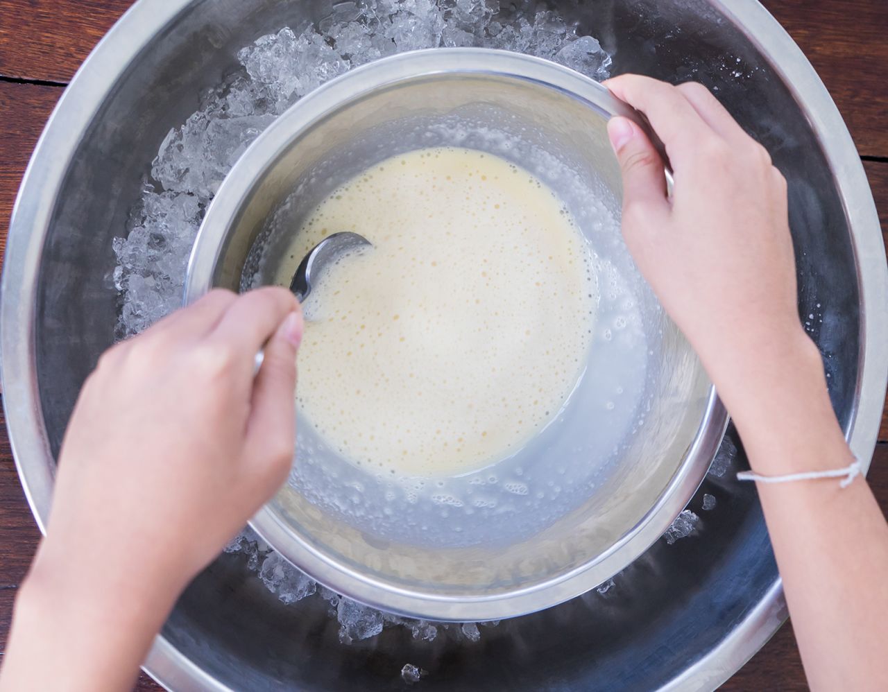 Churning an ice cream base by hand, in an ice cold bowl.