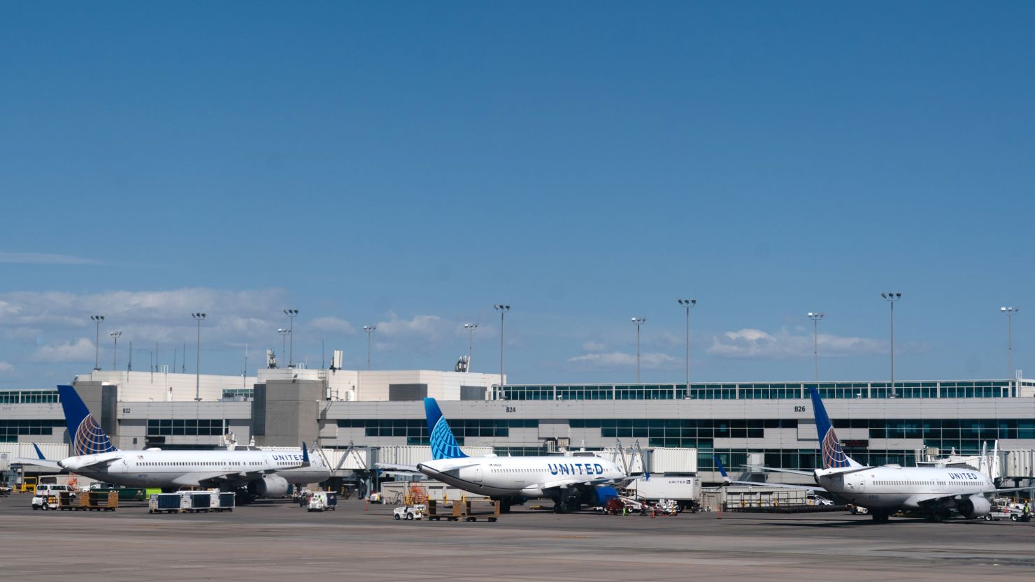 United Airlines Holdings Inc. planes parked at gates at Denver International Airport in Denver, Colorado, U.S., on Thursday, April 8, 2021. U.S. airlines are bringing back more pilots as they prepare for an expected travel rebound. 