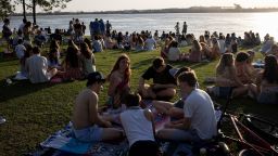 College students from Tulane spend Friday evening socializing on the banks of the Mississippi River on March 18 in New Orleans. 