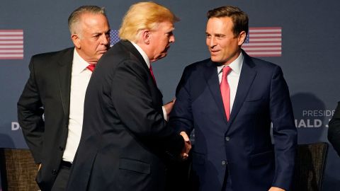 Former President Donald Trump, center, shakes hands with Nevada GOP Senate nominee Adam Laxalt, right, and Clark County Sheriff Joe Lombardo, the GOP nominee for governor, during an event in Las Vegas last Friday.
