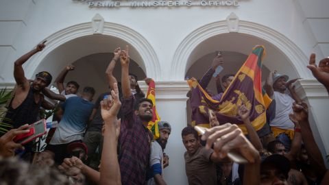 Sri Lankan protesters chant slogans after taking control of the Prime Minister's office in Colombo on July 13.