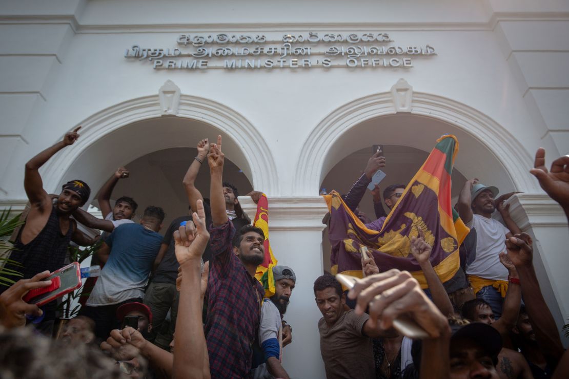 Sri Lankan protesters chant slogans after taking control of the Prime Minister's office in Colombo on July 13.