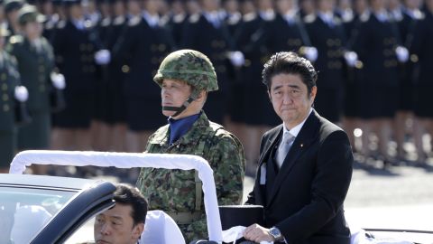 Shinzo Abe inspects Japan's Self-Defense Forces at Asaka Base, north of Tokyo, in 2013. 