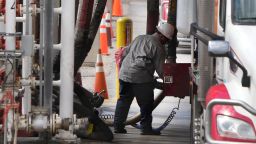 A driver hooks hoses up to fill his tanker with gas and diesel to deliver to stations at Marathon Refinery on May 24, 2022 in Salt Lake City, Utah.