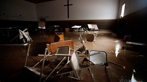 Chairs and pews sink down in mud inside Baptist Bible Church, Thursday, July 14, 2022, in Whitewood, Virginia, following a flash flood.