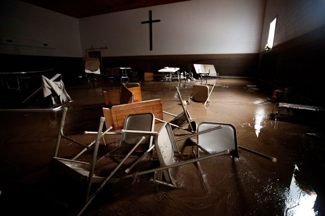 Chairs and pews sink down in mud inside Baptist Bible Church, Thursday, July 14, 2022, in Whitewood, Virginia, following a flash flood.