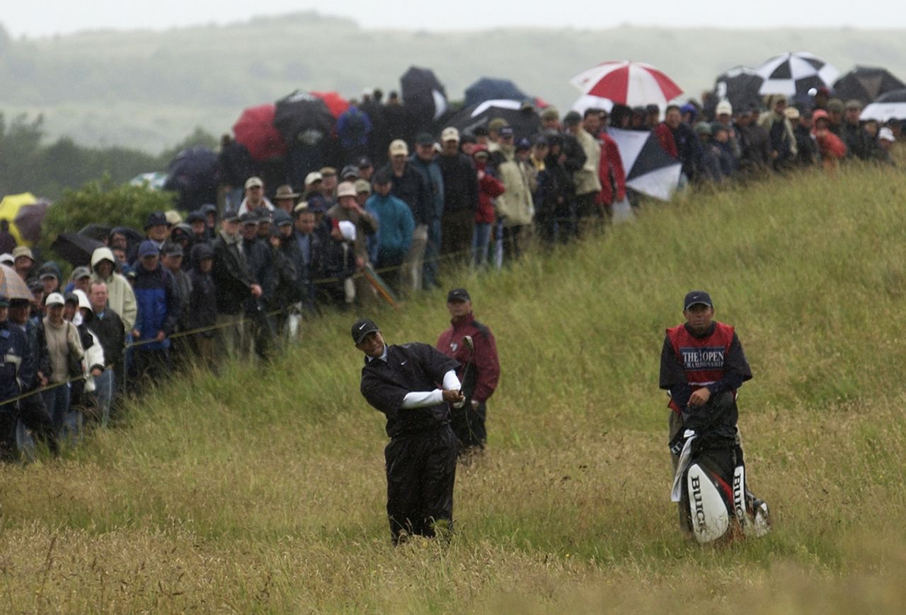 <strong>Tiger Woods swinging (and swinging and swinging) in the rain, 2002 -- </strong>On a fair day at the Open, life is good. But when it gets wet and wild, the major is a different beast. Woods, who at the time was the reigning Masters and US Open winner, was aiming for a Grand Slam when he arrived at Muirfield in 2002. Then came the rain. In the third round, the world's greatest golfer endured one of the most torrid days of his career, carding an <a href="http://edition.cnn.com/TRANSCRIPTS/0207/20/cst.15.html" target="_blank">81</a> to leave him six over par for the tournament. It was the worst score of his professional career, but he was still able to find the funny side of a bad day, holing his first birdie of the round on the 17th and <a href="https://www.espn.co.uk/golf/theopen/story/_/id/9466803/tiger-woods-recalls-dreadful-third-round-open-muirfield-2002-golf" target="_blank" target="_blank">bowing to the crowd</a>. 
