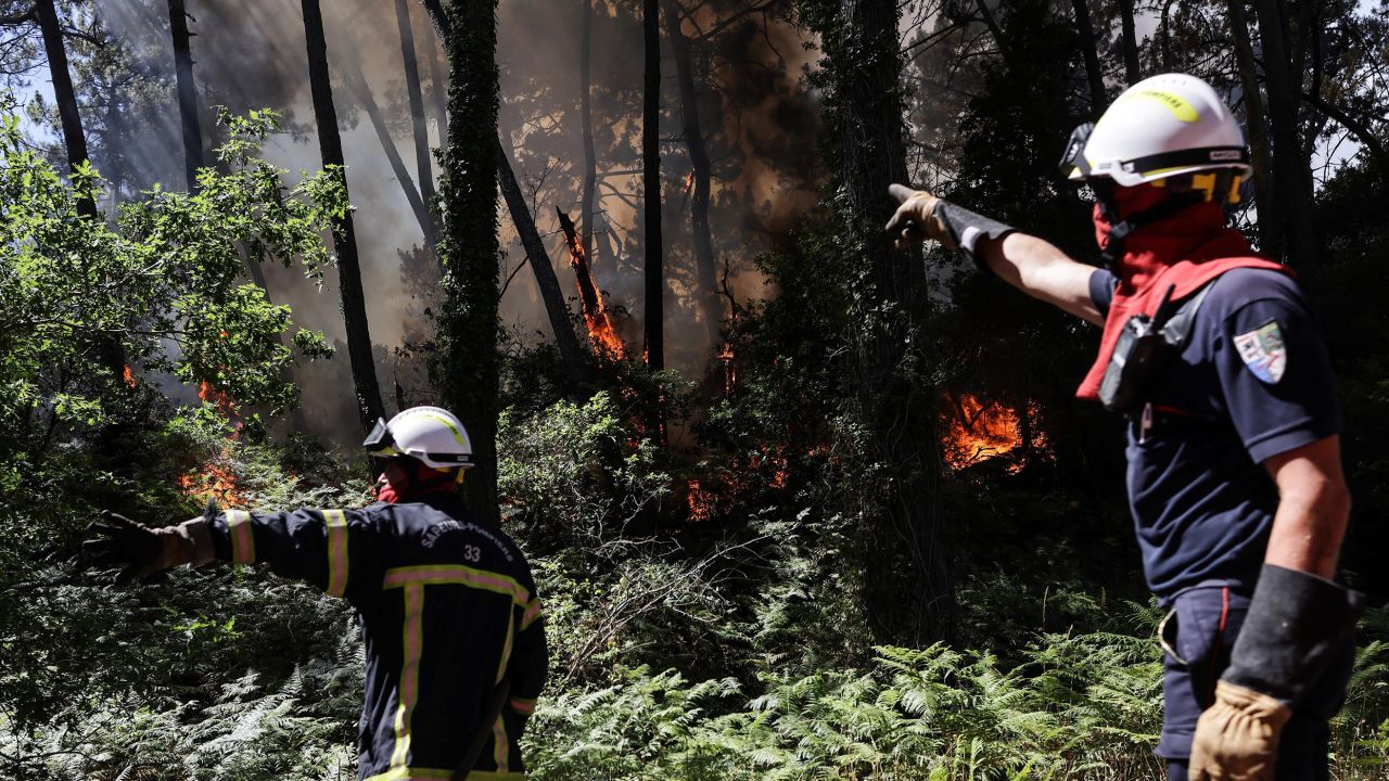 Firefighters work to extinguish a wildfire which broke out at the bottom of the Dune du Pilat near Teste-de-Buch, southwestern France on July 13.