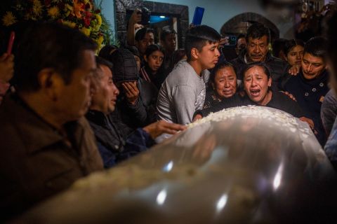 Relatives and friends react as the bodies of Jair Valencia, Misael Olivares and Yovani Valencia arrive to a house in San Marcos Atexquilapan, Mexico, on Wednesday, July 13. They were three of the 53 migrants <a href="https://www.cnn.com/2022/06/29/us/san-antonio-migrant-truck-deaths-charges-filed/index.html" target="_blank">who died inside a semitruck in San Antonio</a> last month.