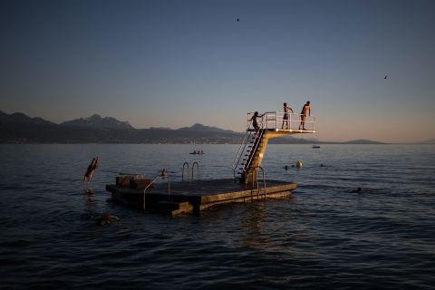 People dive into Lake Geneva from a platform in Lutry, Switzerland, on Wednesday, July 13. <a href="http://www.cnn.com/2022/07/07/world/gallery/photos-this-week-june-30-july-7/index.html" target="_blank">See last week in 36 photos.</a>